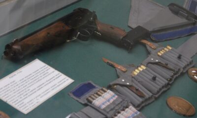 Pistolet de survie TP-82 avec sa machette-crosse et sa bandoulière de munitions en vitrine
