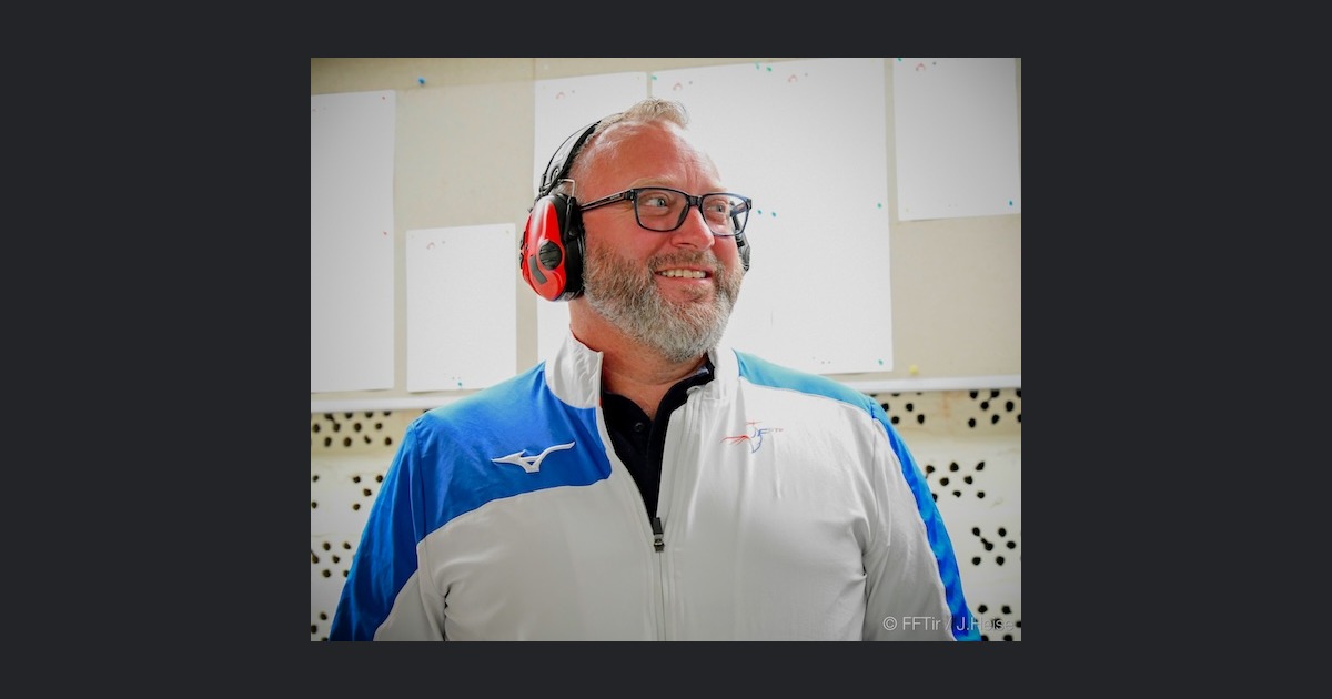 Julien Boutmard souriant au pas de tir, en veste de l'équipe de France